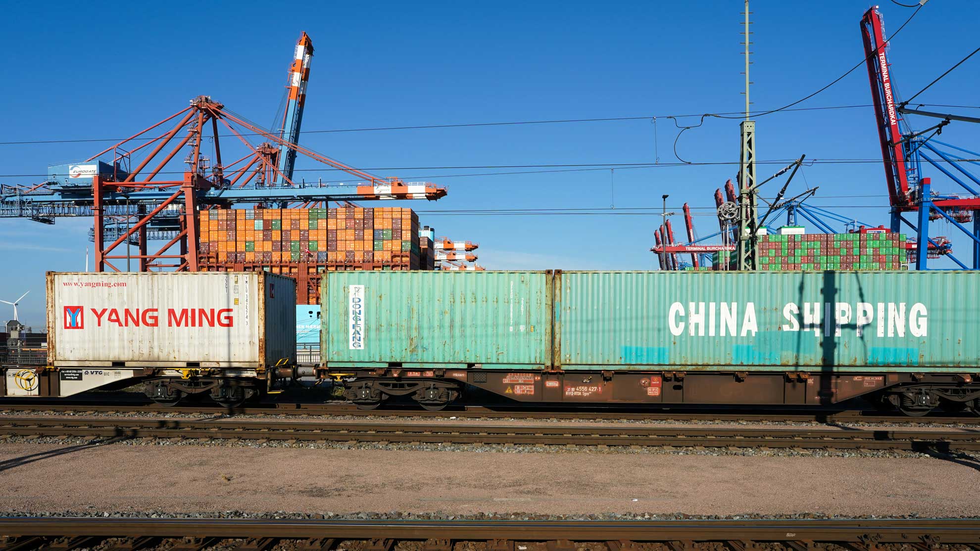 Shipping containers on a train at a port representing cross border sales of goods between related group companies